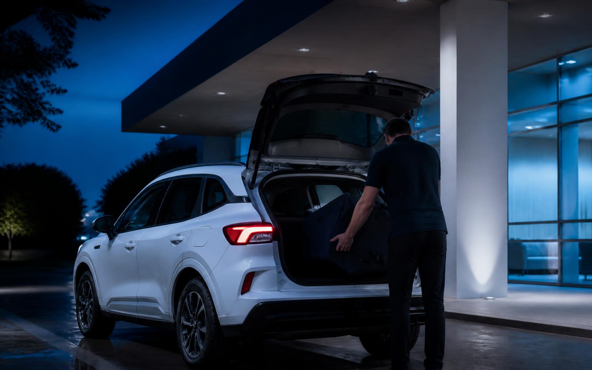 White healthcare logistics vehicle loading a secure medical transport case at a modern medical facility entrance at dusk